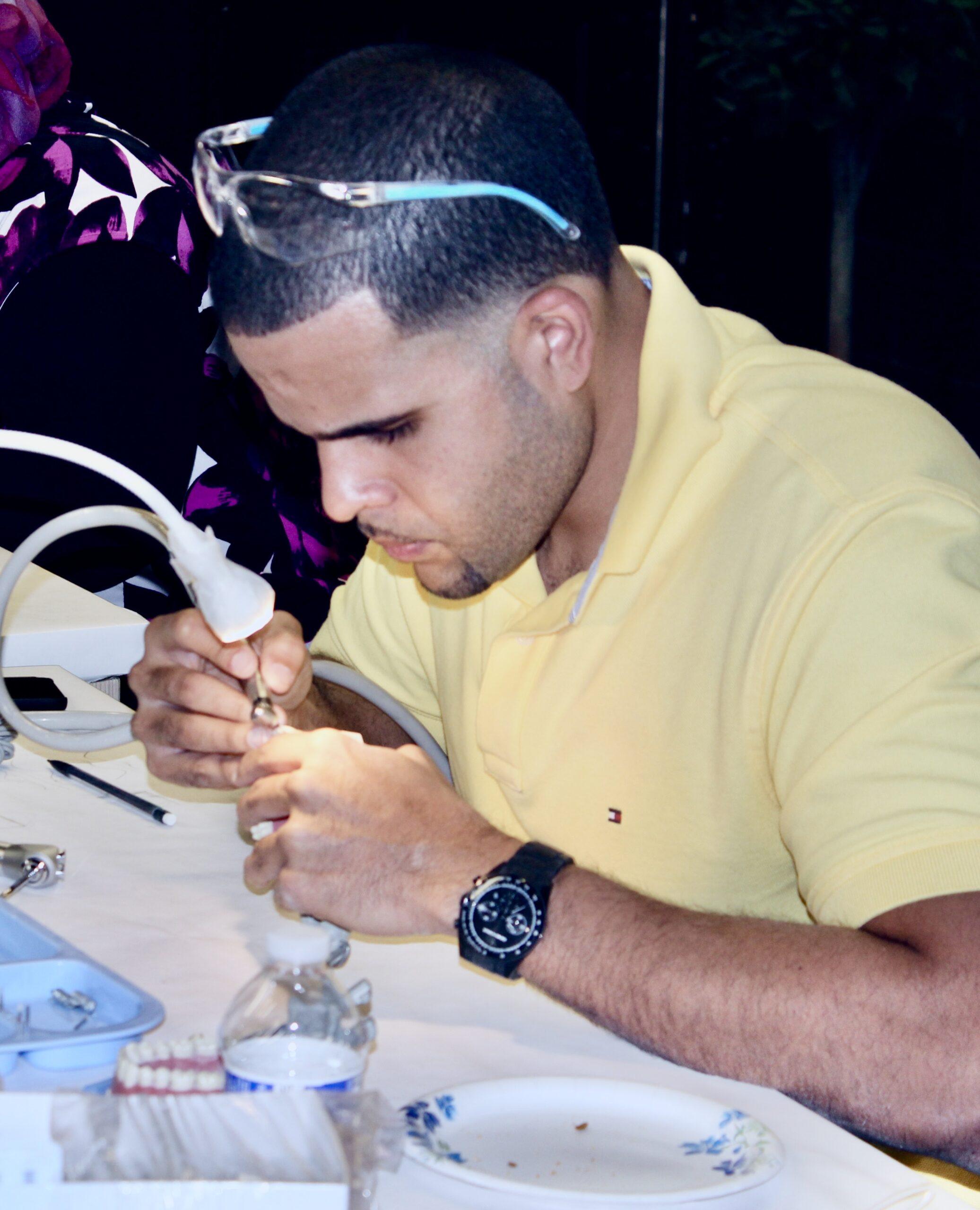 student working on typodont